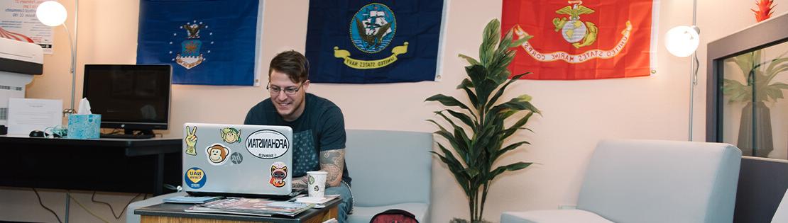 A military student works on his laptop in a Pima Veterans Center